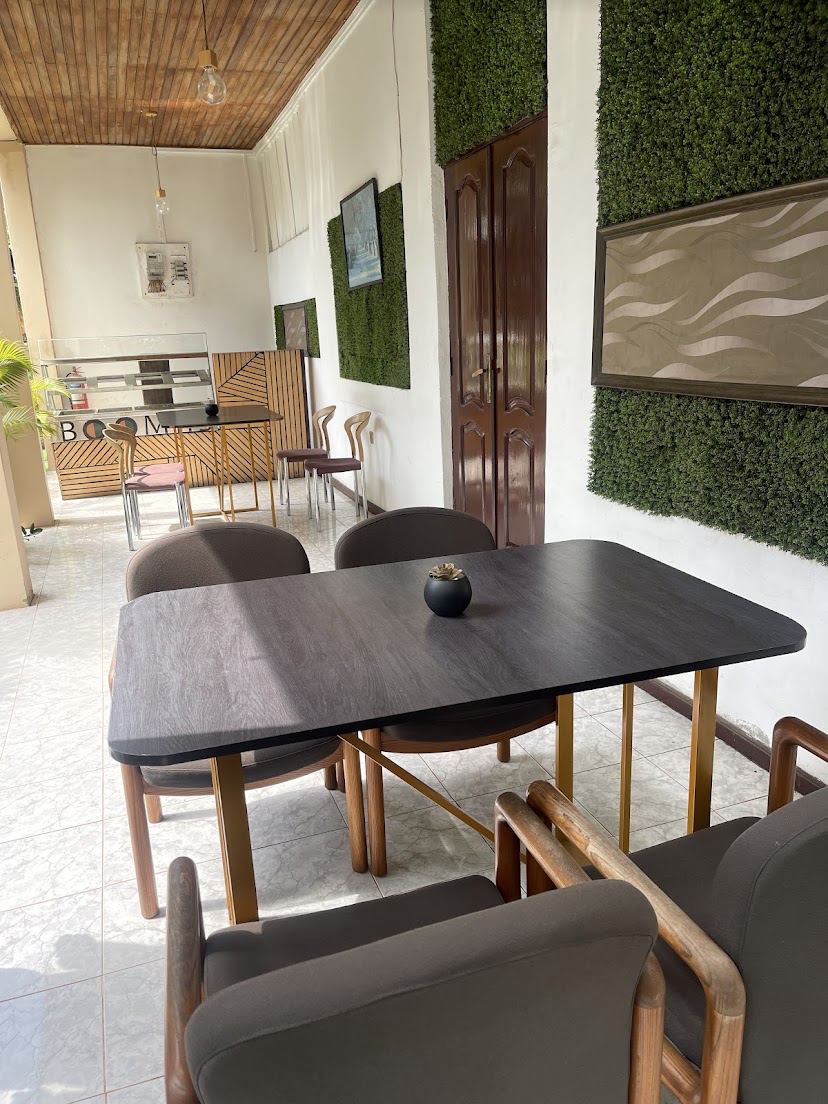 Lounge with green living walls and dark wood tables